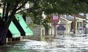 Flooding waters from the Big Connoquenessing Creek flow through the main street of Harmony following the heavy rains from Hurricane Ivan.